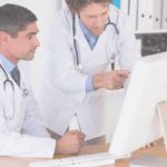 Doctors looking at the medical data entered by Virtual OfficeWare coding specialists