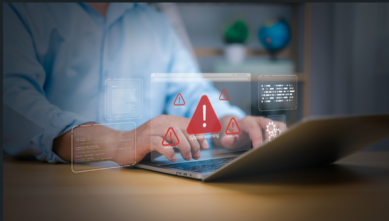 Doctor using laptop with system warning icons representing cyber threats and data security risks.