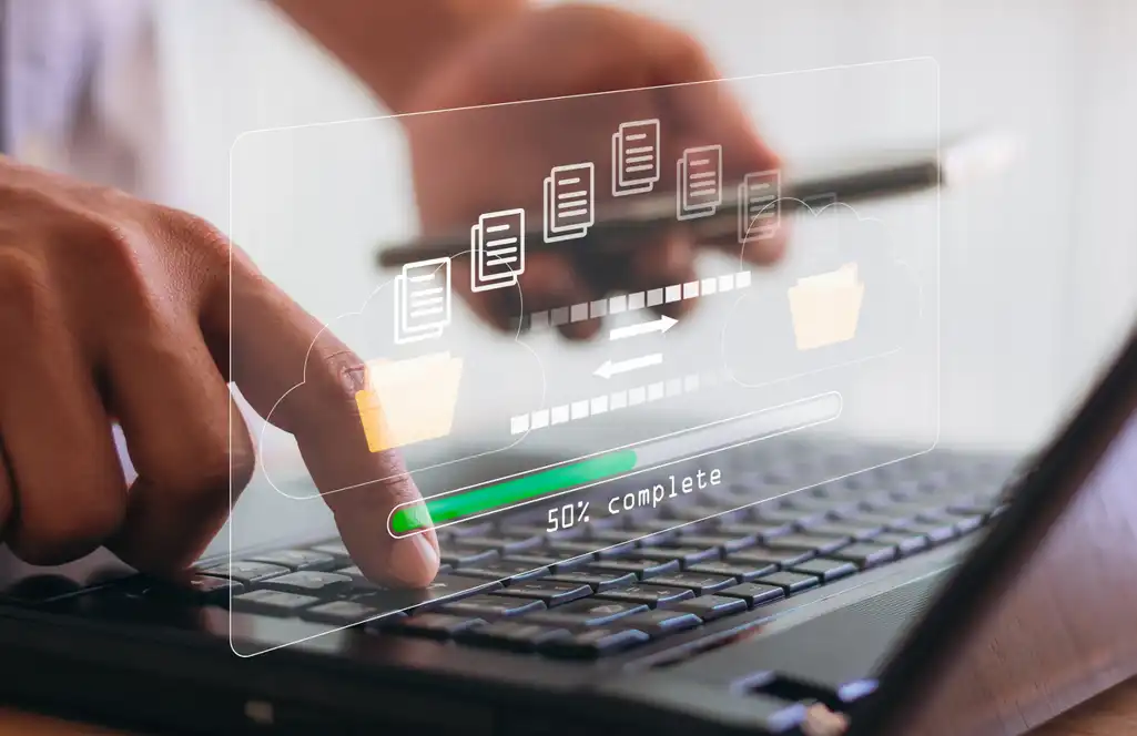 Person using a laptop to upload procedure fee schedules with progress bar at 50%