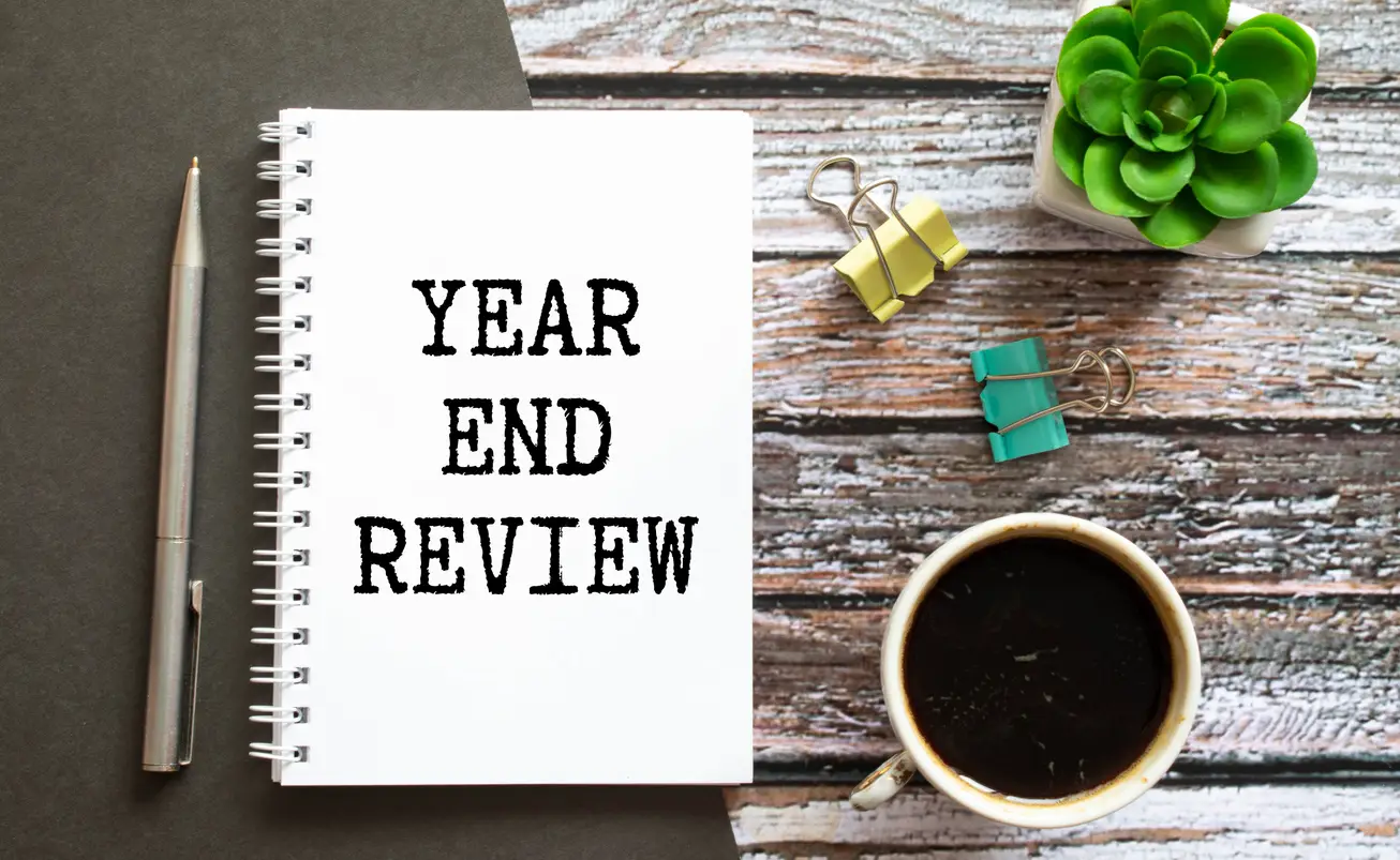 year-end medical practice review - A notebook titled Year End Review sitting on wooden table