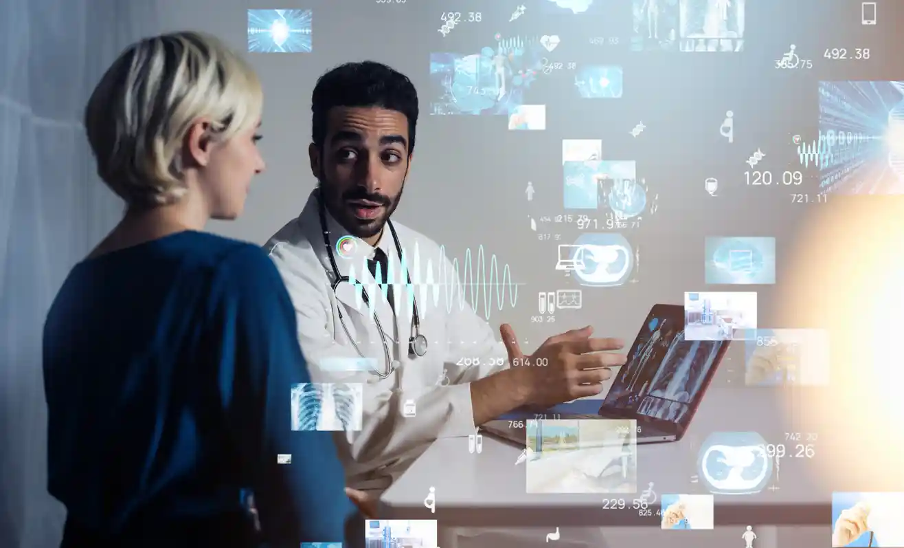 Physician balancing patient care with digital technology during an office visit.