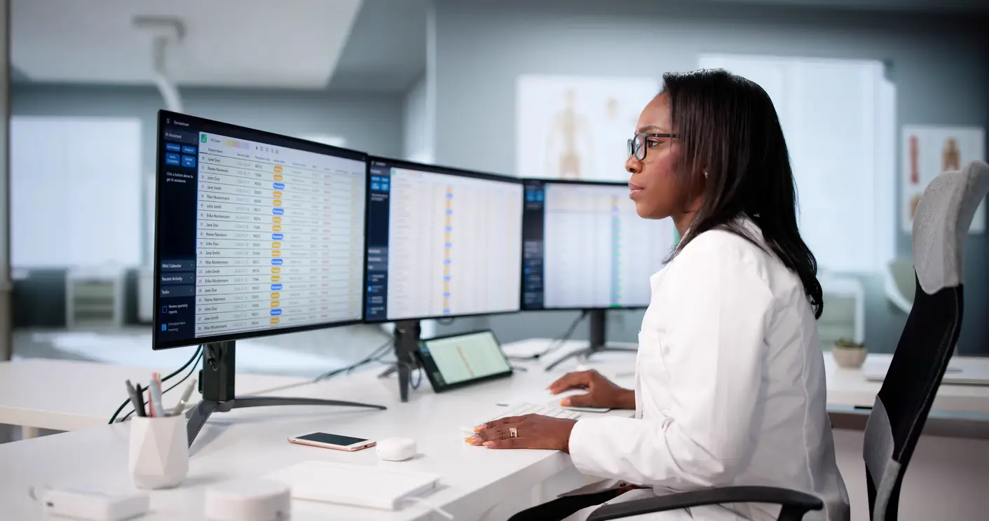 Practice Administrator reviewing EHR and PM system to reduce coding errors and revenue leakage