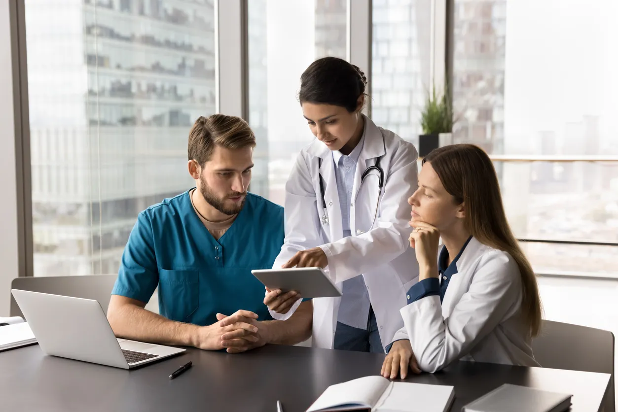Healthcare team reviewing patient engagement data on a digital platform to improve care coordination and patient outcomes.
