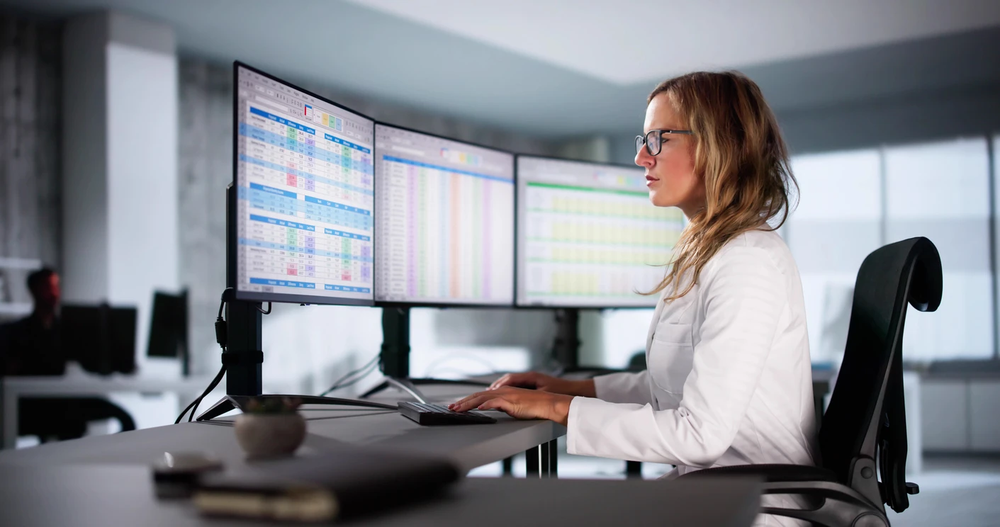 Healthcare biller reviewing denied insurance claims and revenue cycle errors in an ambulatory practice office