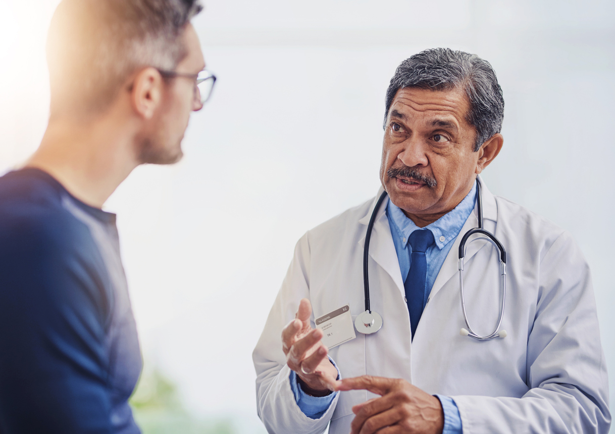 Internal Medicine - Hand gesture, medical or process with doctor and patient in hospital for appointment, assessment or checkup. Checklist, explain and healthcare with medicine professional talking to man in clinic