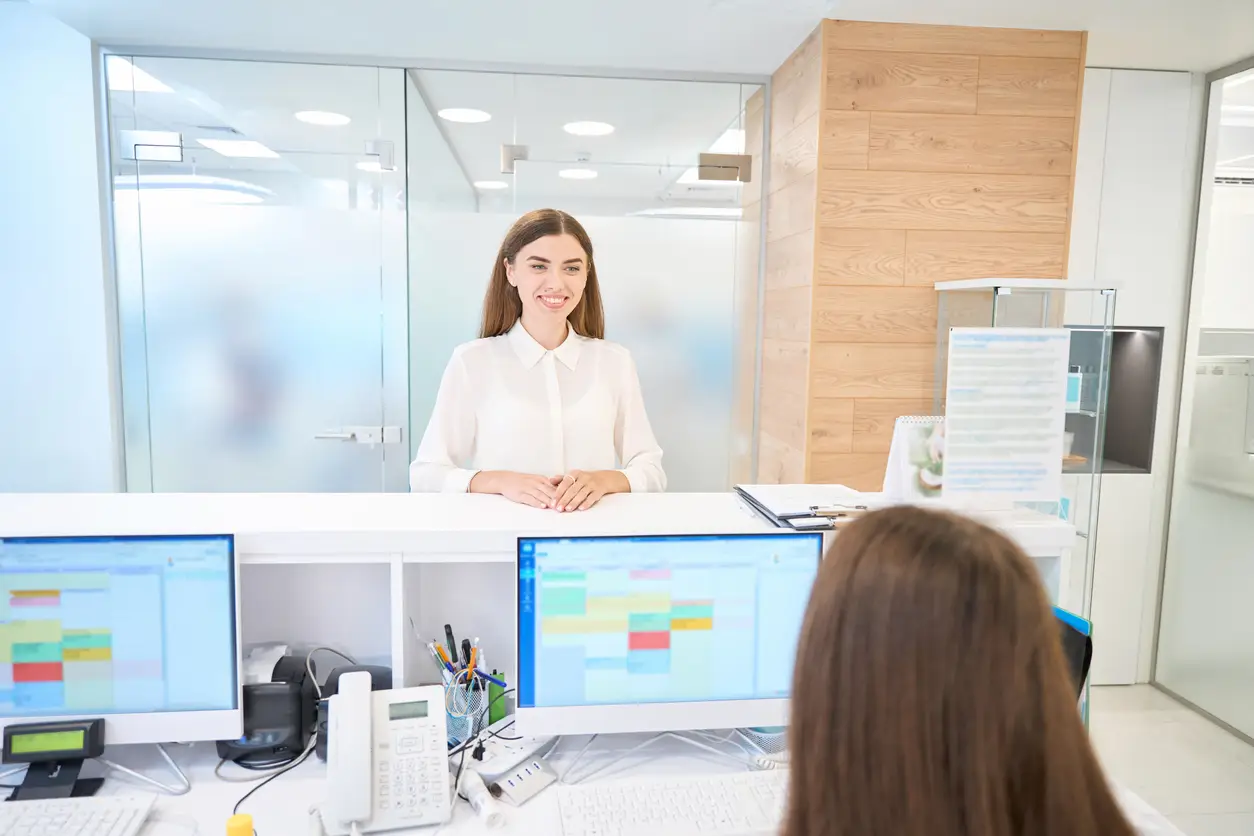 Healthcare office staff using digital scheduling software to reduce patient no-shows and improve appointment management