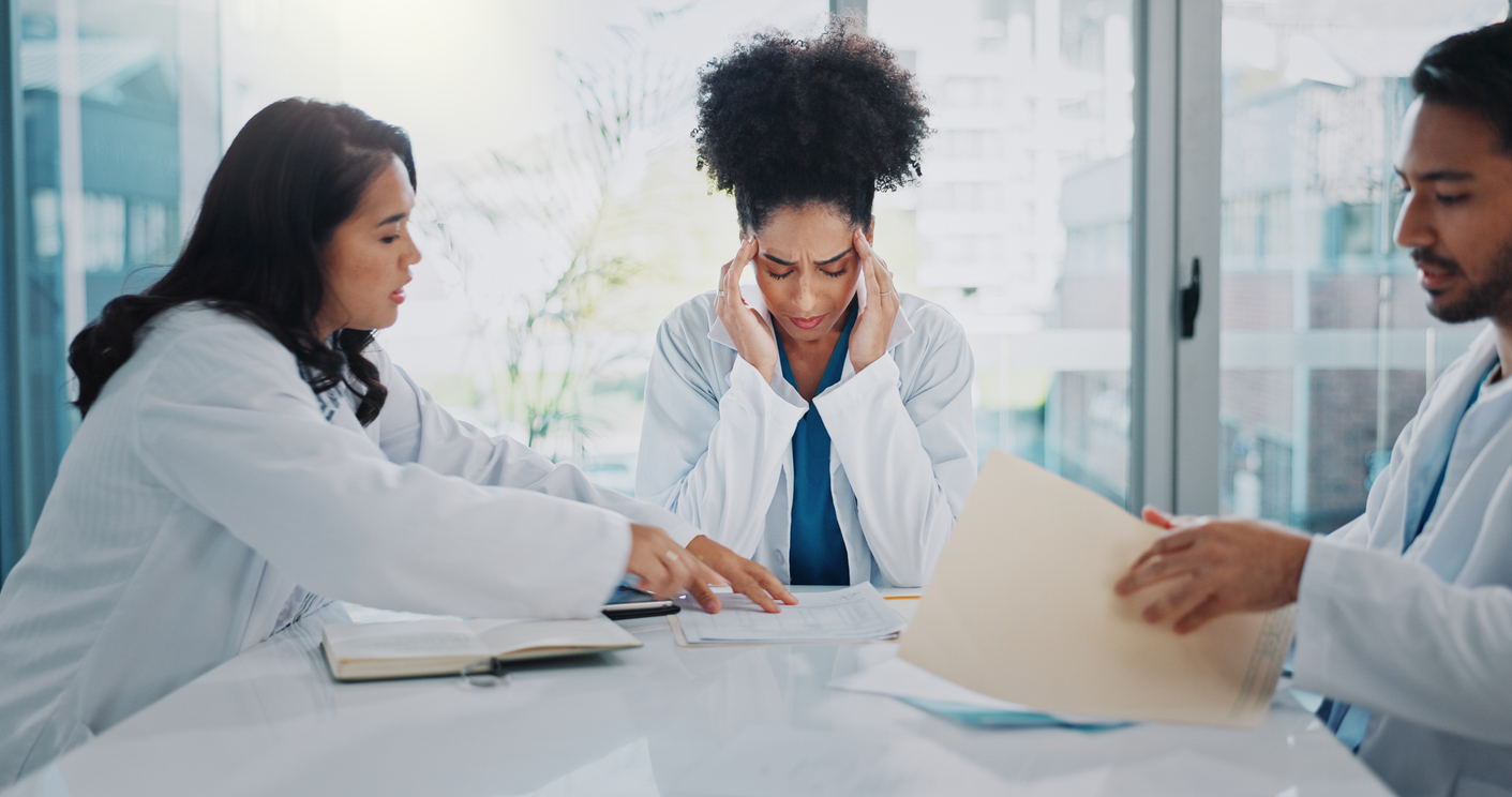 Healthcare staff showing signs of fatigue and burnout during a busy workday in a medical practice