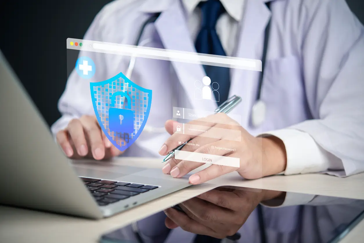 Healthcare physician using AI-powered cybersecurity monitoring software to protect patient data