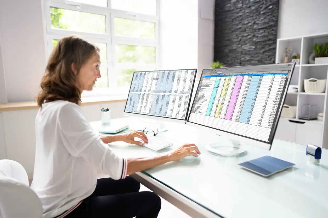 Medical biller reviewing a claim affected by payer EM downcoding that may reduce reimbursement for an ambulatory practice