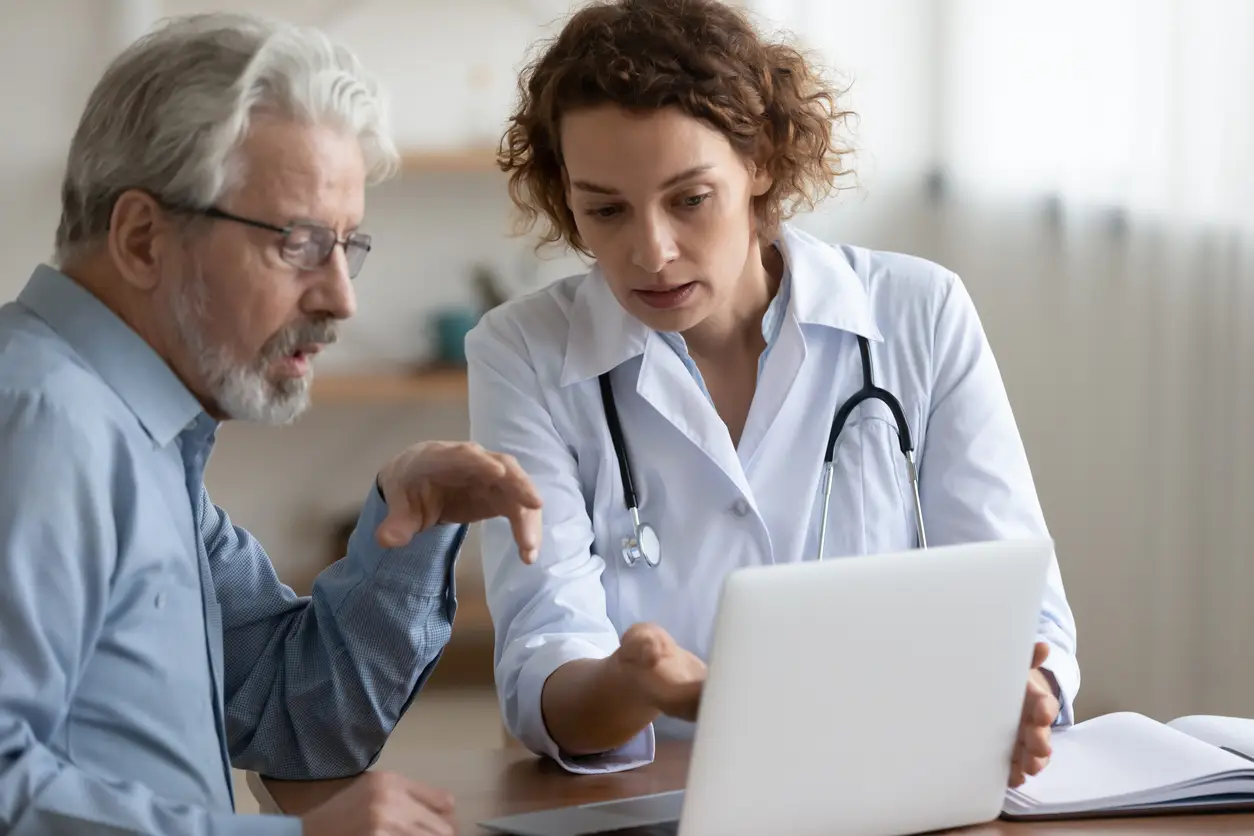 Medical physician using EHR and practice management software to streamline prior authorization workflows