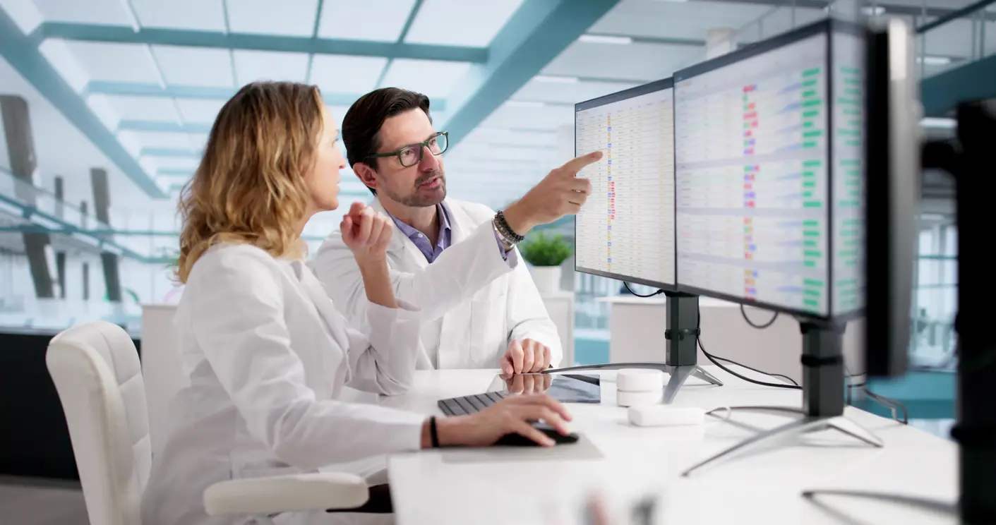Physician and practice manager reviewing Medicare reimbursement and revenue-cycle performance